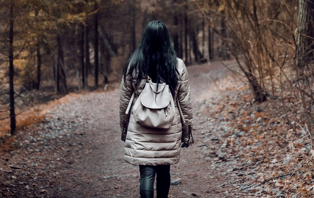 Eine Frau geht im Wald spazieren