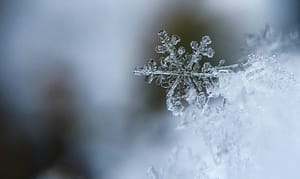 Eine vergrößerte Schneeflocke auf gefrorenem Schnee